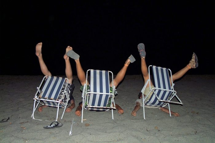 Crazy teenage beach boys fooling around