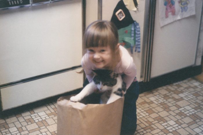 Cat's out of the bag: Little Girl Holding Cat, Unamused Cat From Childhood