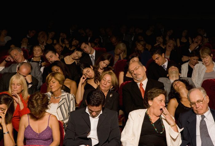 Hispanic people sleeping in theatre