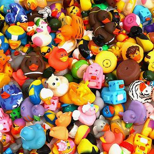 Rubber ducks are scattered in a colorful pile, featuring various colors, costumes, and designs.