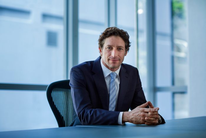 Confident businessman sitting at conference table