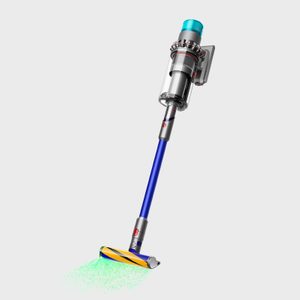 Cordless vacuum projects green laser onto floor, highlighting dirt particles; sleek design with blue and silver color scheme against a plain background.