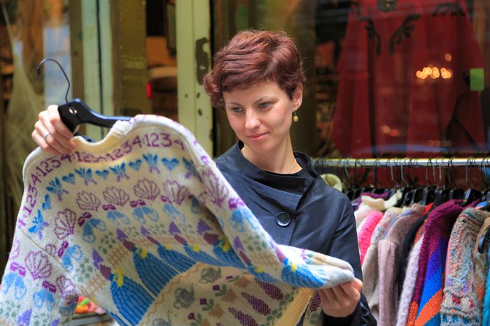 Young woman shopping for vintage clothing
