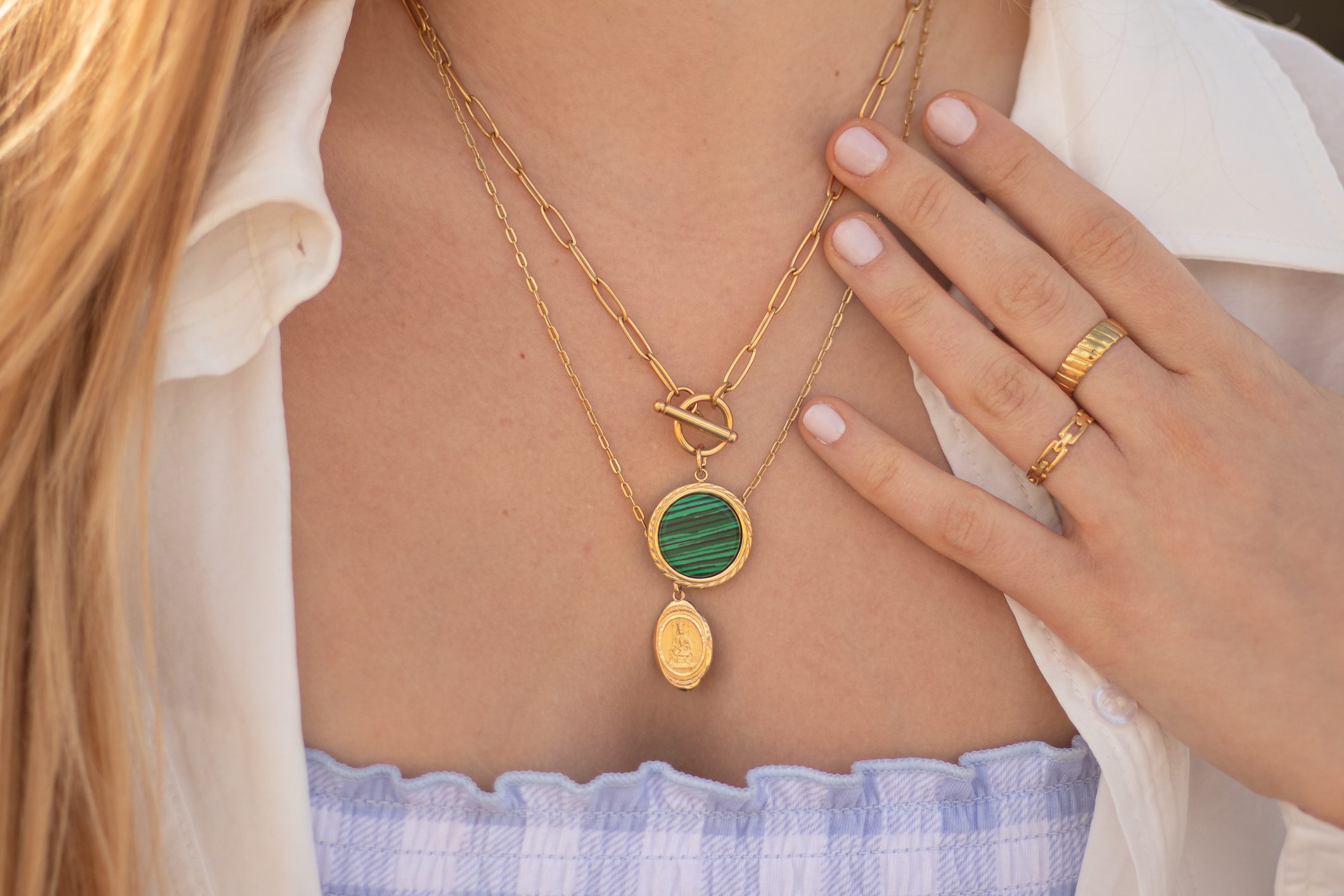 Beautiful girl wearing golden jewerly, a golden necklace and golden rings