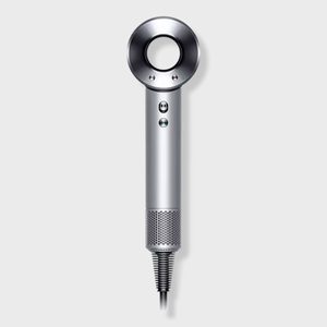 A sleek, silver hairdryer with a circular opening, vertical orientation, featuring buttons on the handle, set against a plain grey background.