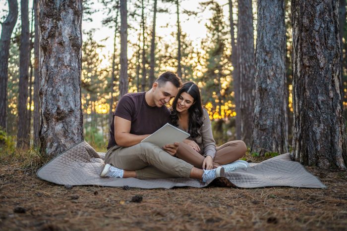 reading love poems in a woodsy park