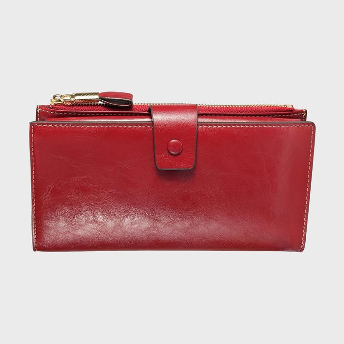 Red leather wallet with a snap closure, positioned against a plain white background.