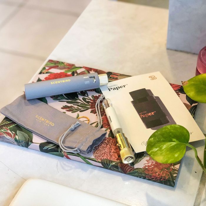 Perfume samples and pouch placed on floral box, accompanied by 
