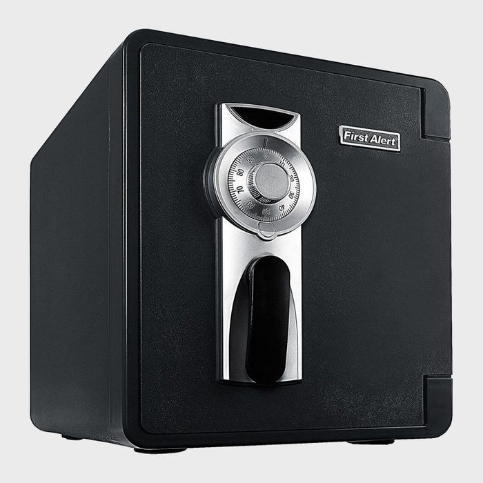 A black safe displays a combination lock and handle, set against a plain background. Text reads 