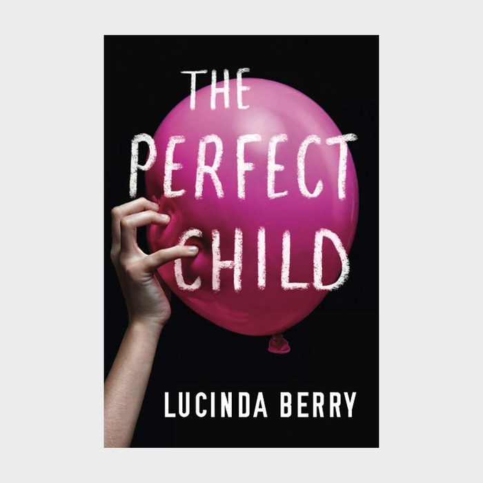 A hand holds a pink balloon with white text, 