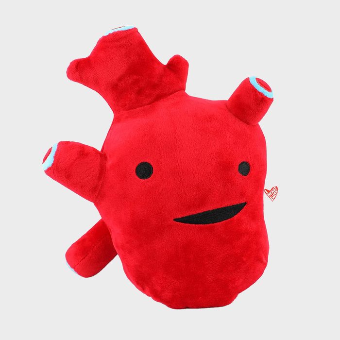 Red plush heart toy smiling with simplistic facial features, set against a plain gray background. Small text reads: 