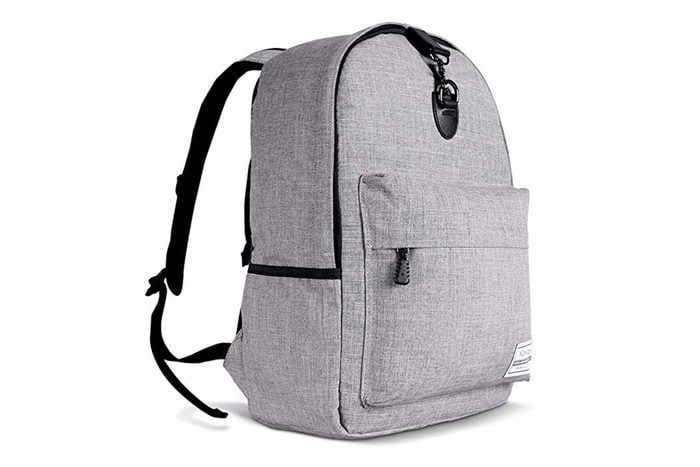 A gray backpack sits upright, featuring a front pocket and a buckle, with black straps, set against a plain white background.