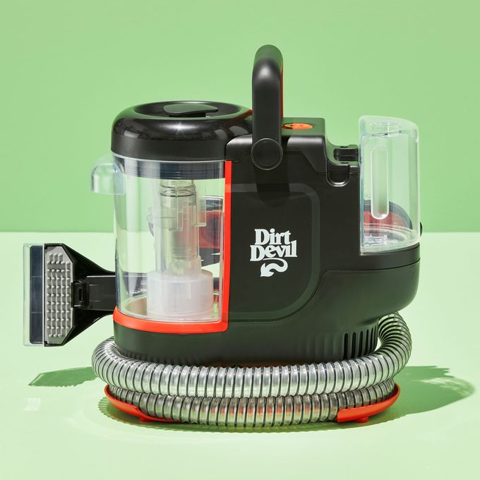 Vacuum cleaner displayed motionless, coiled hose around base, labeled 