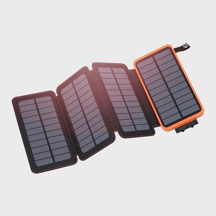 Foldable solar charger unfolds, revealing four connected solar panels, each framed in black, with an orange border, against a plain white background.