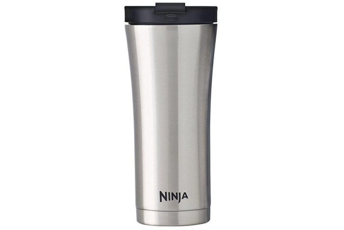 A silver stainless steel travel mug stands upright against a white background, featuring a black lid and 
