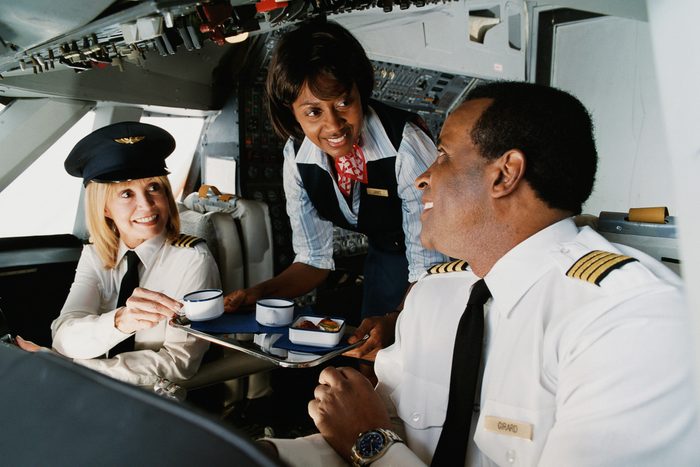 air hostess serving pilot and copilot