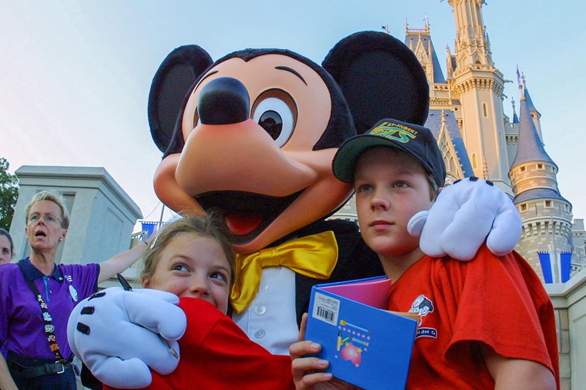 Walt Disney character Mickey Mouse greets children at Magic Kingdom