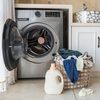 Basket with laundry and washing machine
